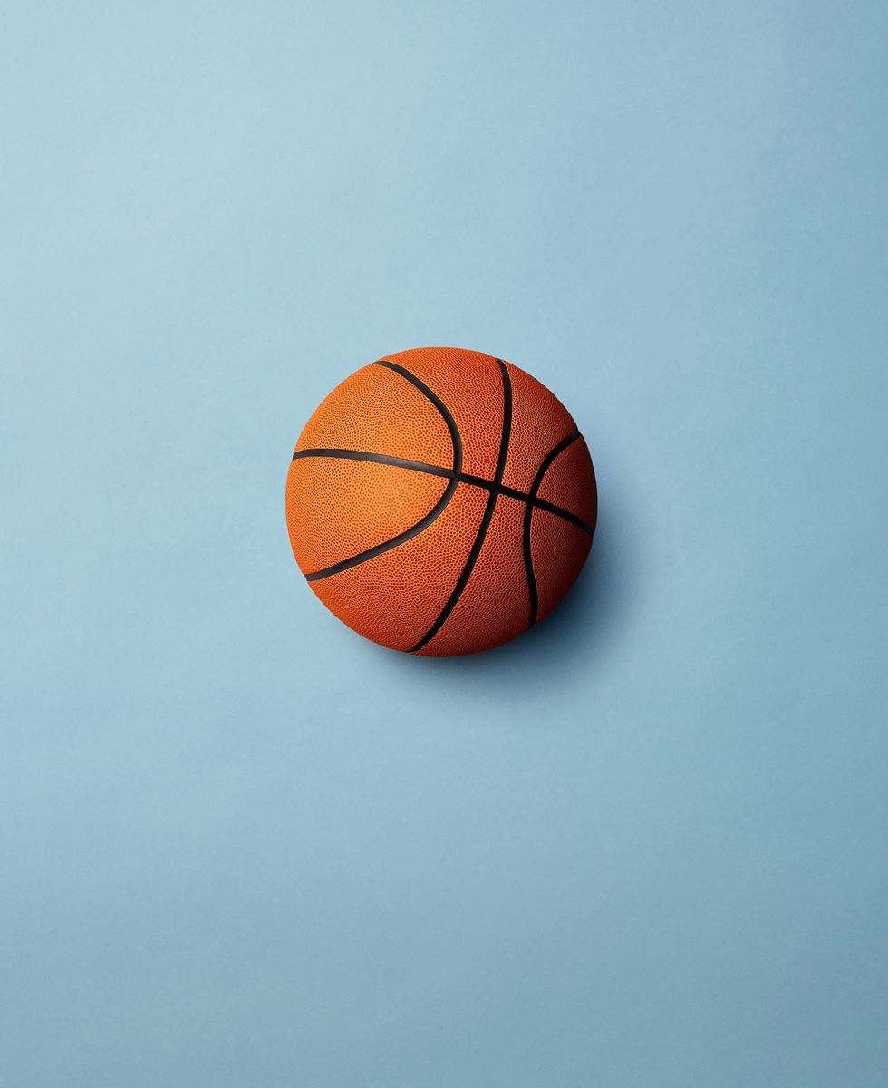 A basketball centered on a light blue background.