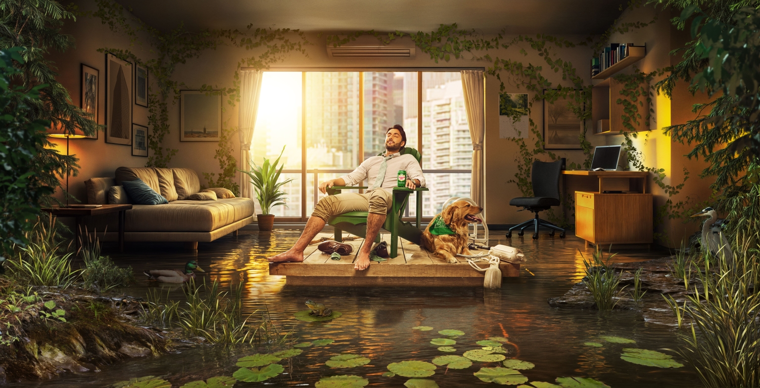 Man relaxes in a lawn chair with a dog on a floating dock inside a flooded, plant-filled living room.